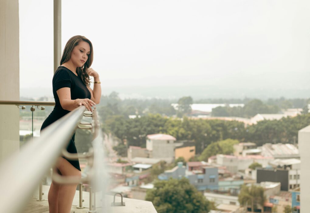 Aavmaal lifestyle — stylish woman enjoying a calm city view from balcony