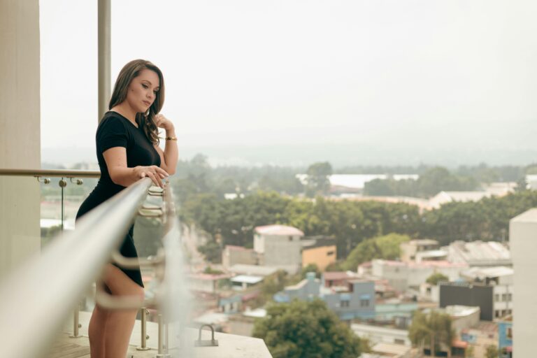 Aavmaal lifestyle — stylish woman enjoying a calm city view from balcony